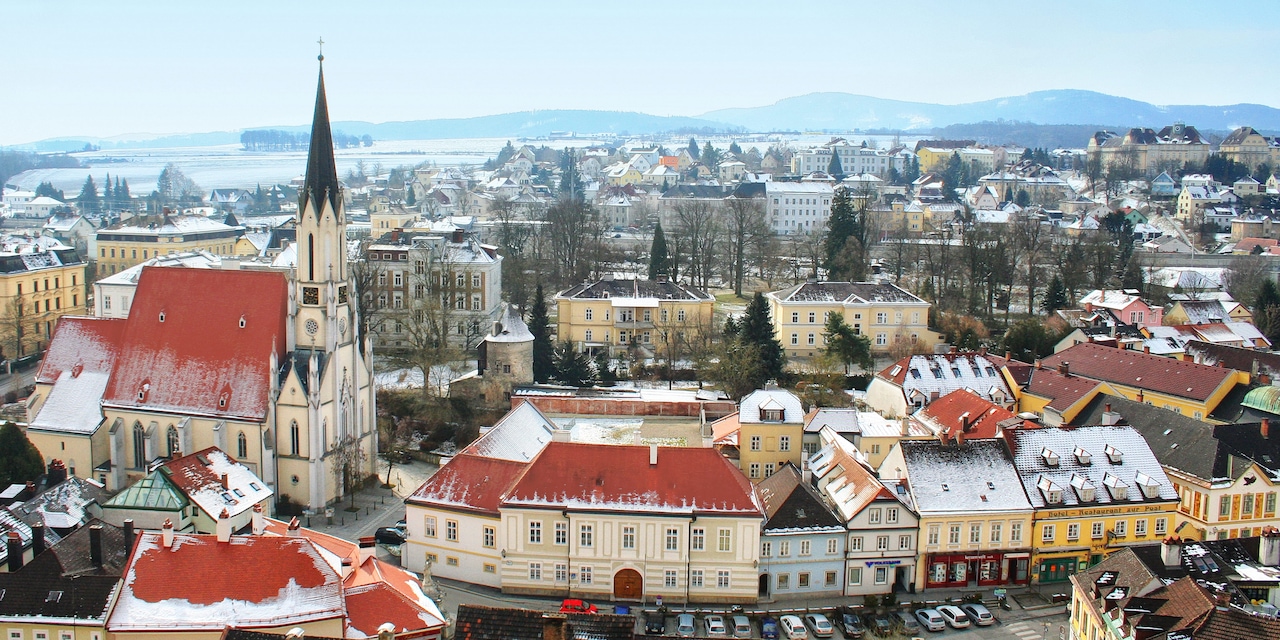 The quaint city of Melk with a steepled church and roofs lightly dusted with snow