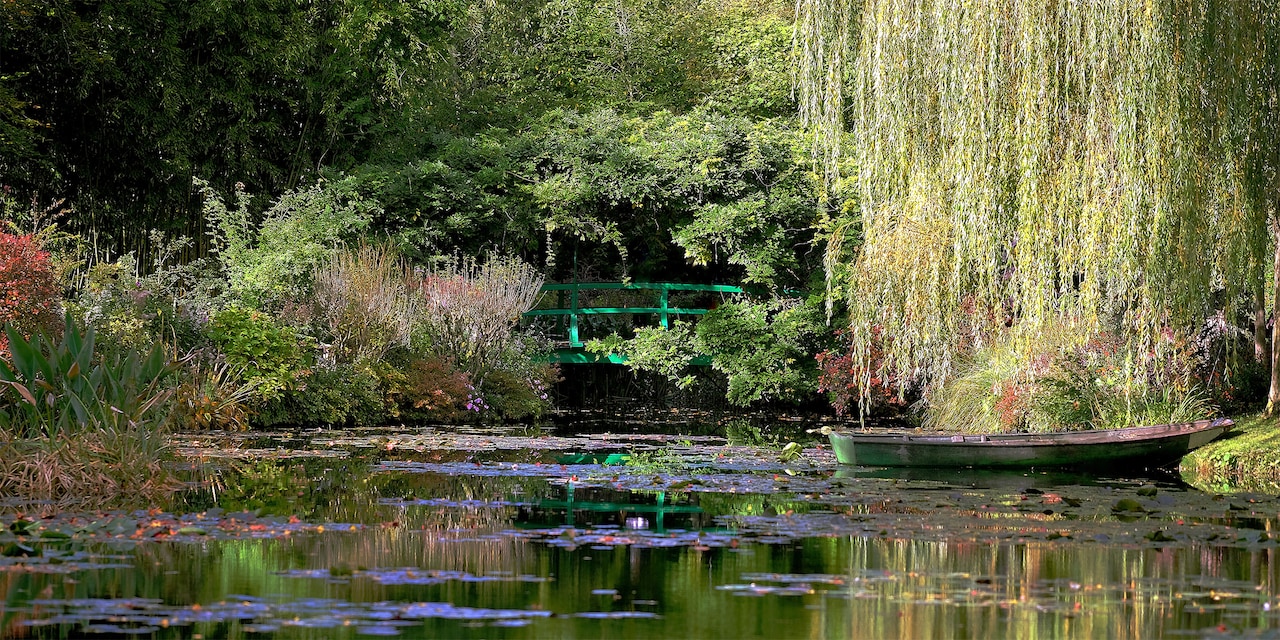 A rowboat sits in the pond amongst the gardens at the house of Claude Monet in Giverny, France