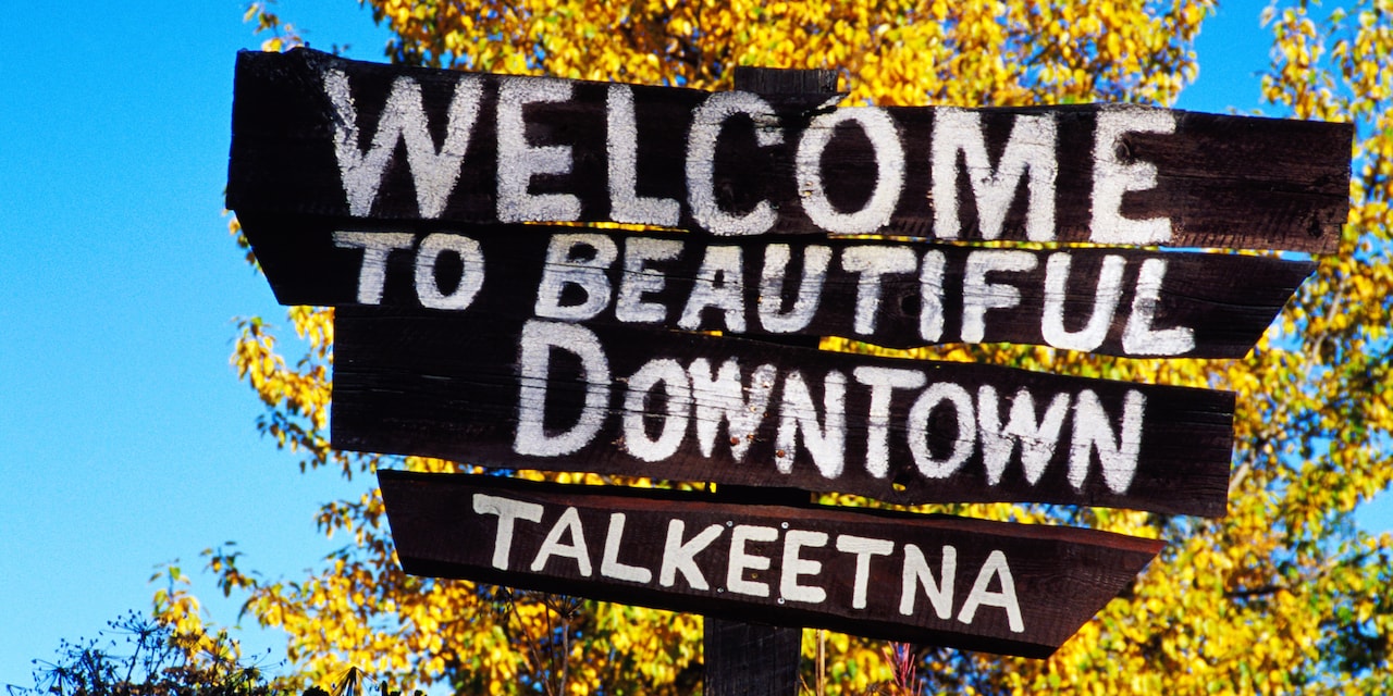 A sign reads 'Welcome to beautiful downtown Talkeetna'