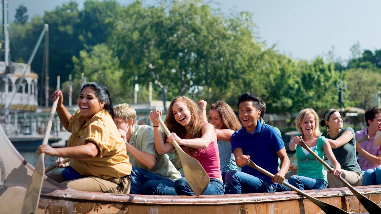 Varios Visitantes felices reman en una canoa