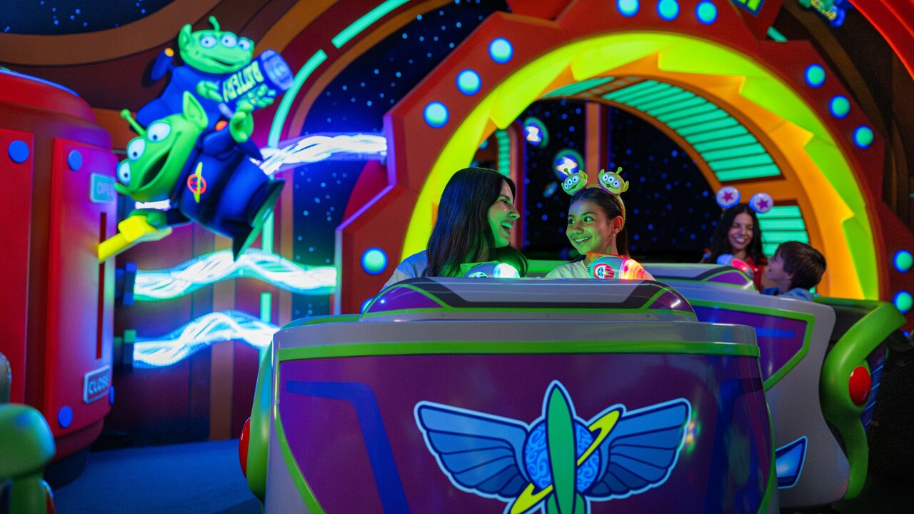 Guests smiling as they ride Buzz Lightyear's Space Ranger Spin at Magic Kingdom park