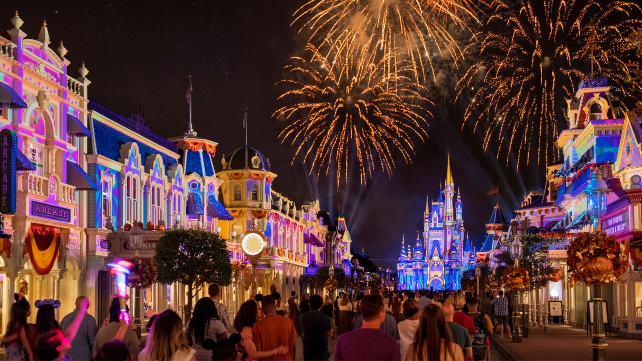 Fireworks bursting over Cinderella Castle as Guests walk down Main Street USA