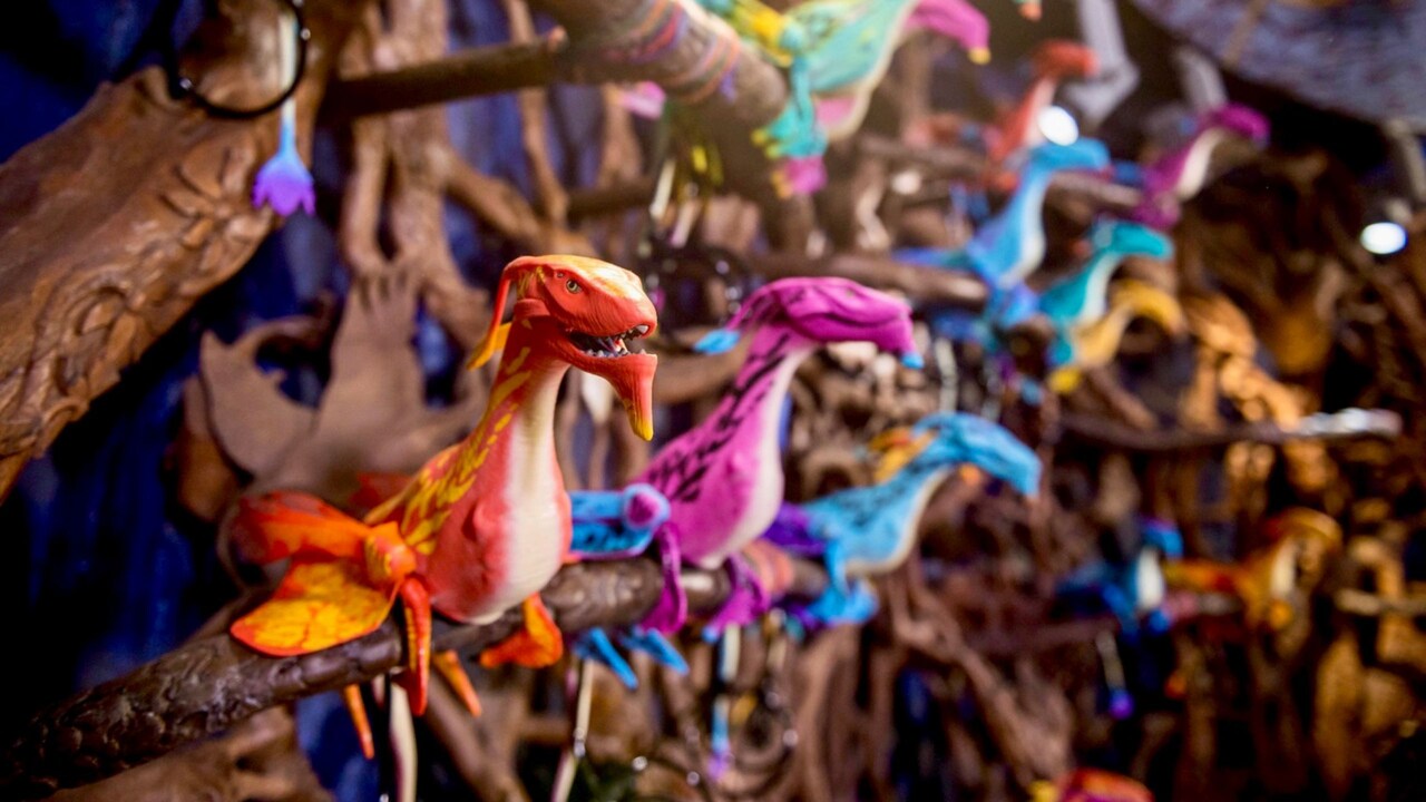 Shoulder banshees perched on a wooden ledge at Windtraders in Disney's Animal Kingdom park