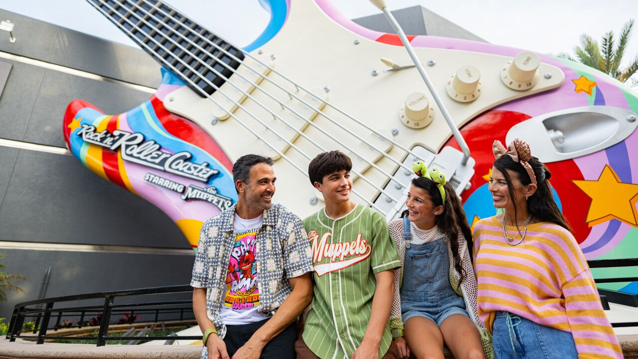 A family of 4 smiling in front of Rock n Roller Coaster Starring the    Muppets at Disney's Hollywood Studios  