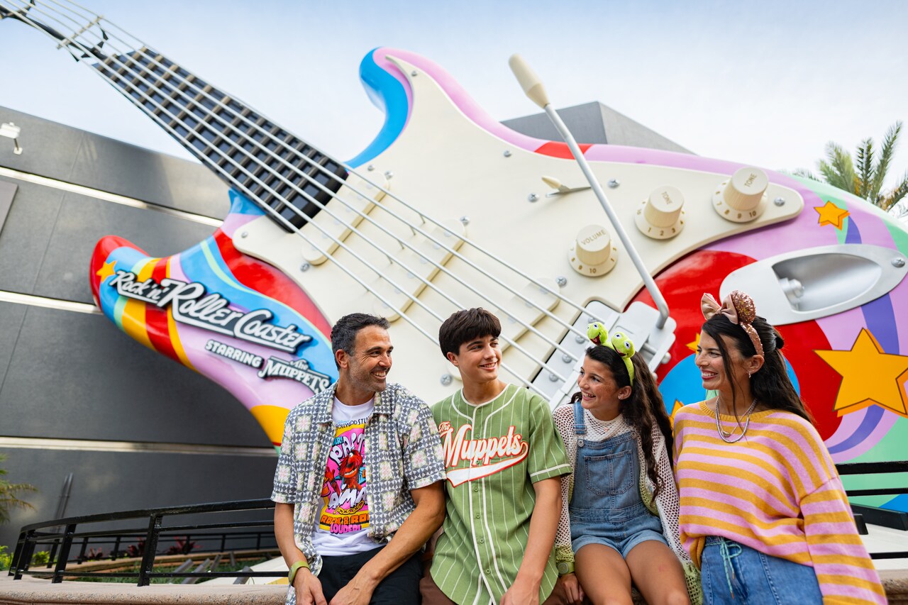 A family of 4 smiling in front of Rock n Roller Coaster Starring the    Muppets at Disney's Hollywood Studios  