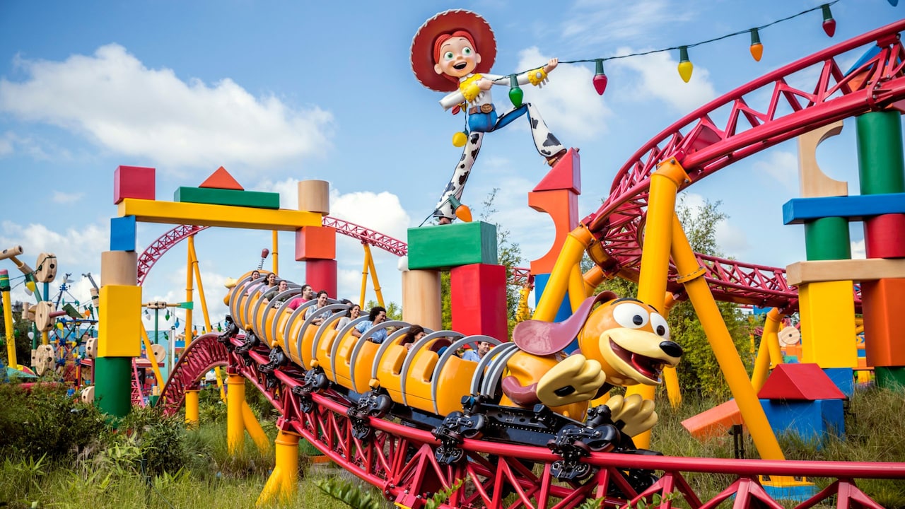 Riders on Slinky Dog Dash racing along the track past giant toy blocks and tinker toys