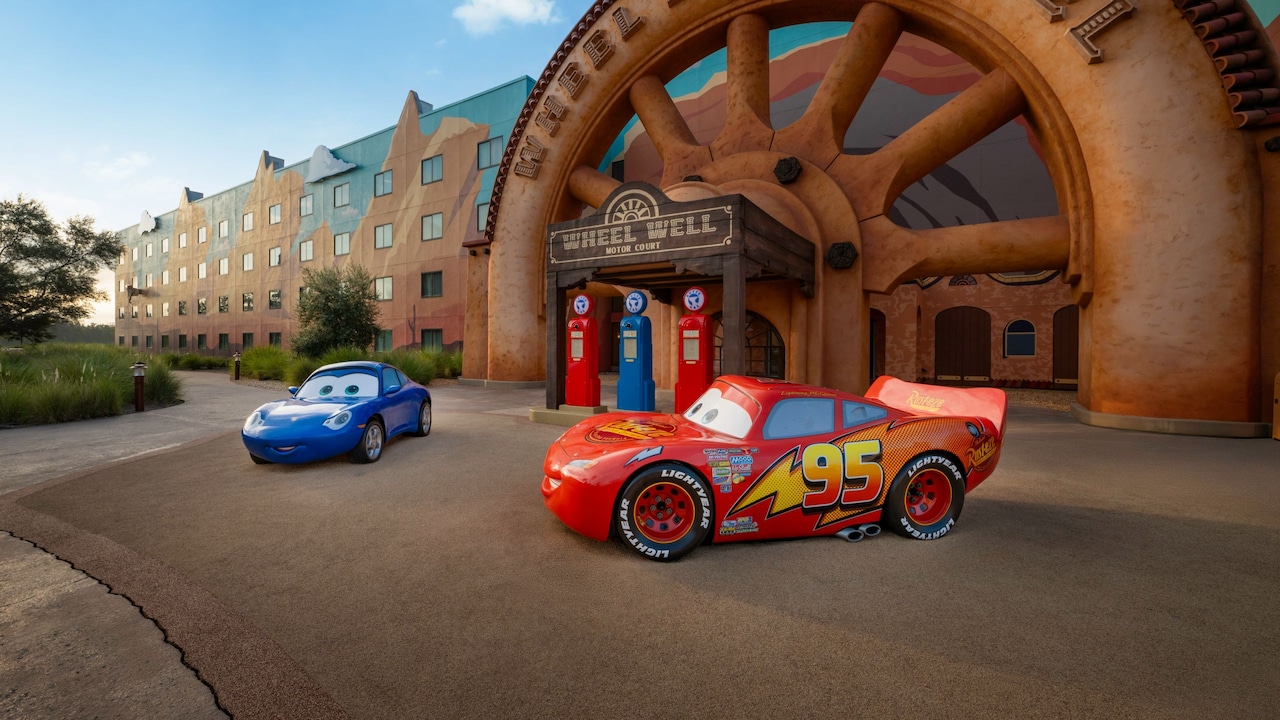 Lightning McQueen and Sally idling in front of a Cars motel at Art of Animation