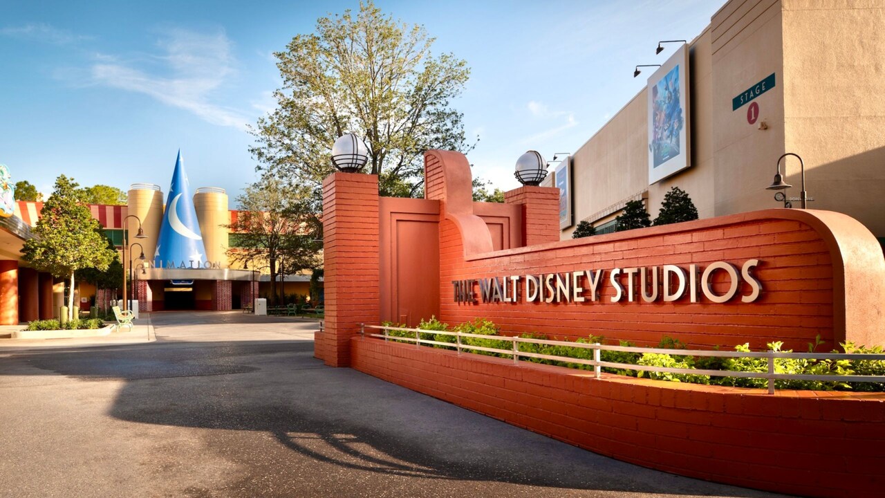 A red brick sign and a large version of The Sorcerer’s Hat at The Walt Disney Studios Courtyard
