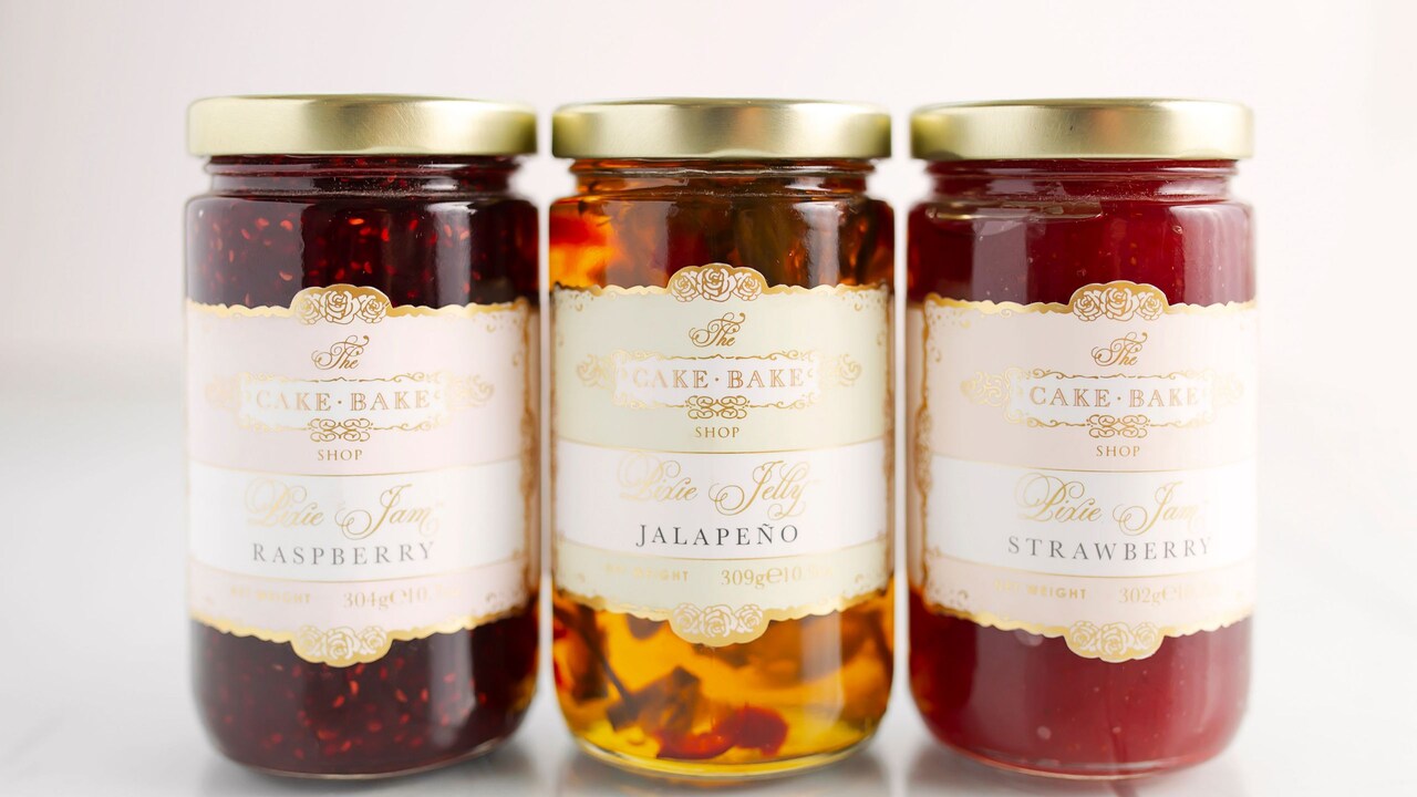 Jars of The Cake Bake Shop Pixie Jam and Pixie Jelly, with flavors of raspberry, jalapeño and strawberry