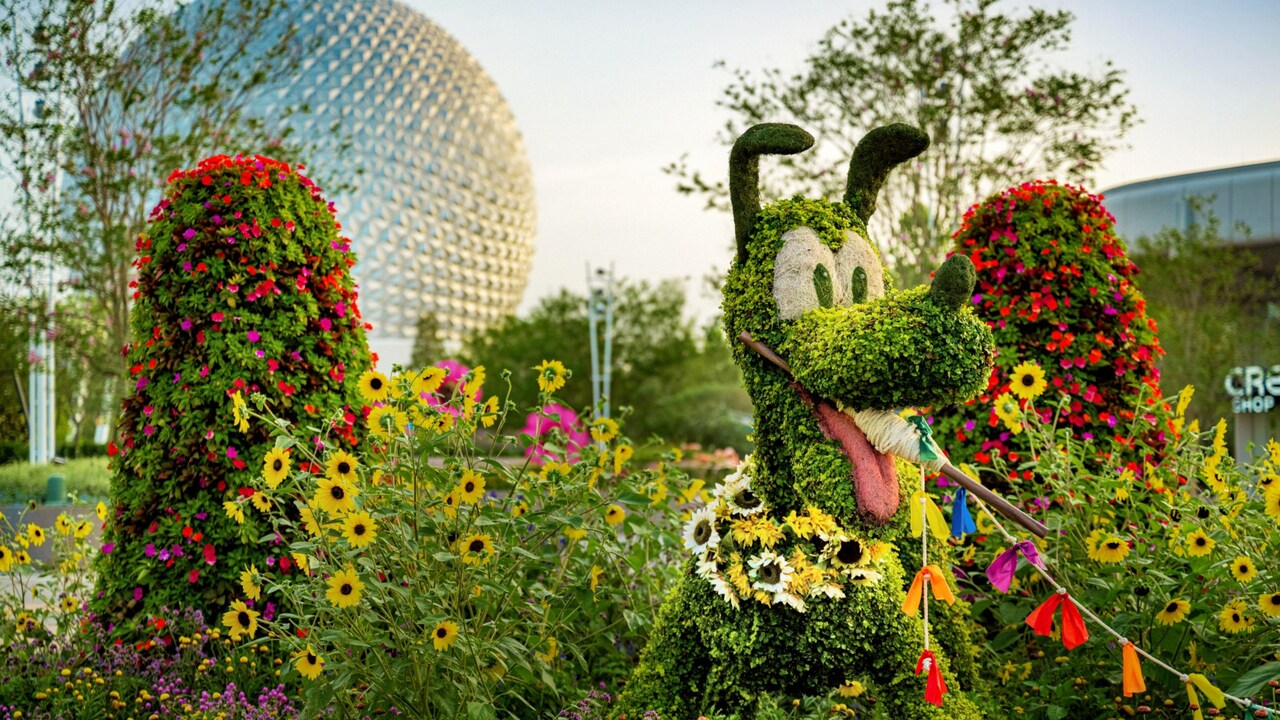 Flowers and shrubs arranged to look like Pluto as he holds a string in his mouth at the Epcot International Flower & Garden Festival