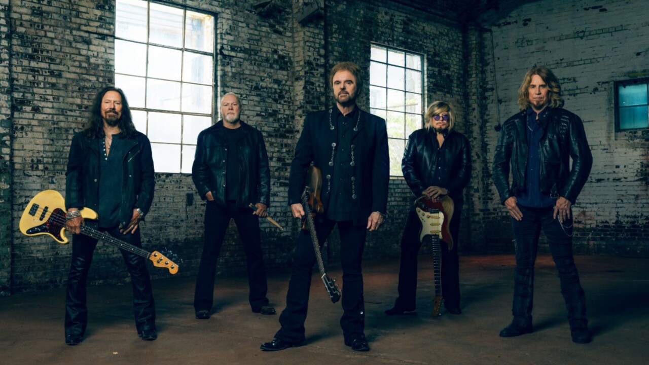 5 members of the group 38 Special standing in an empty warehouse with 2 windows