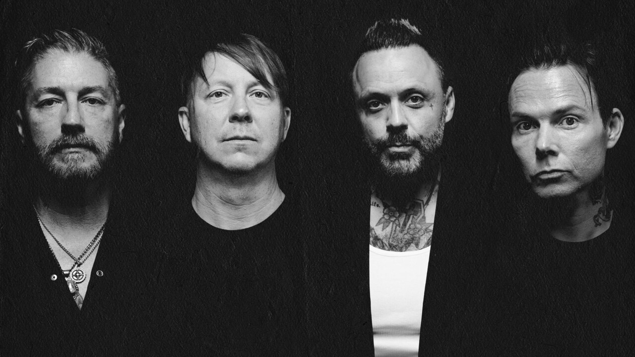 4 members of the group Blue October standing shoulder to shoulder