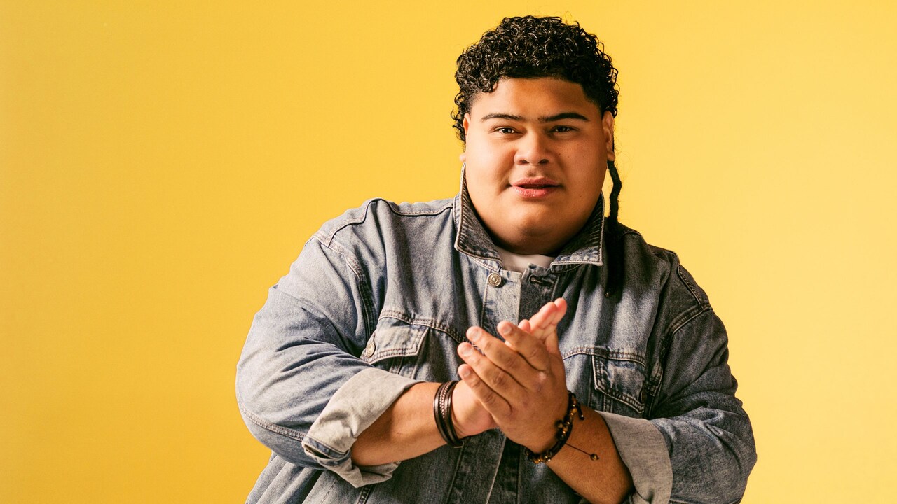 The singer Iam Tongi posing with his hands together