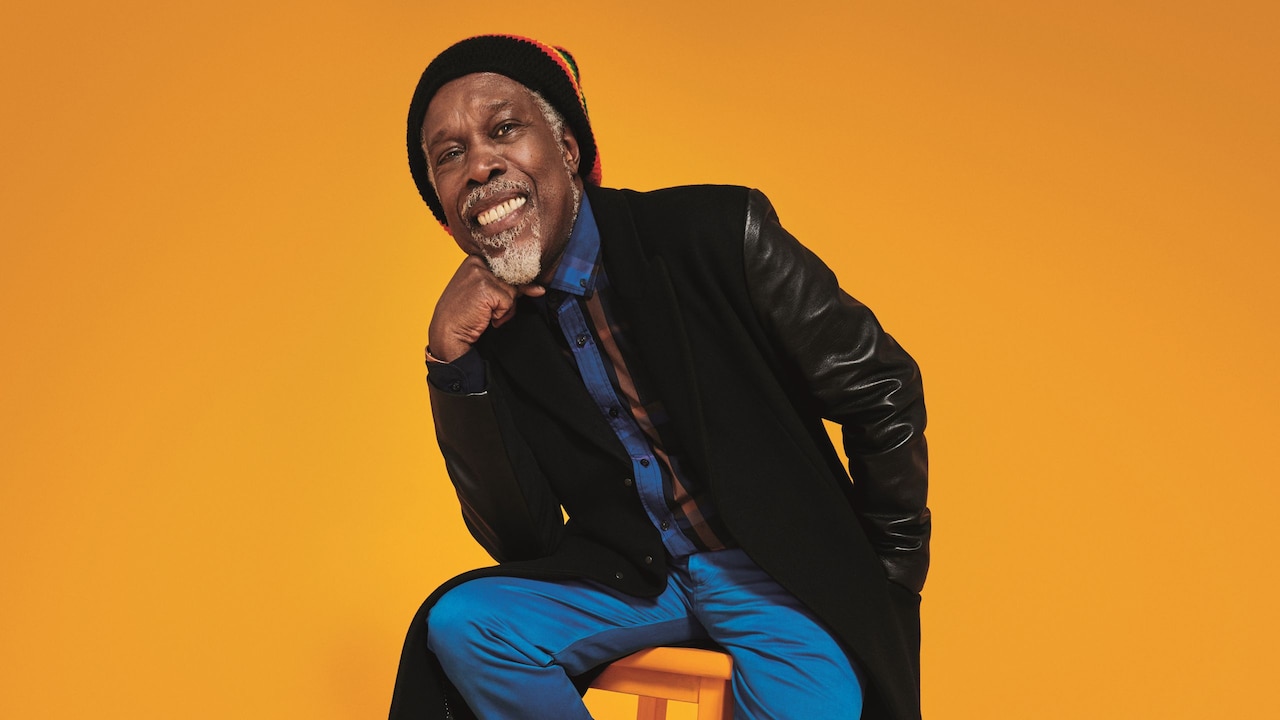 Billy Ocean sitting on a wooden stool