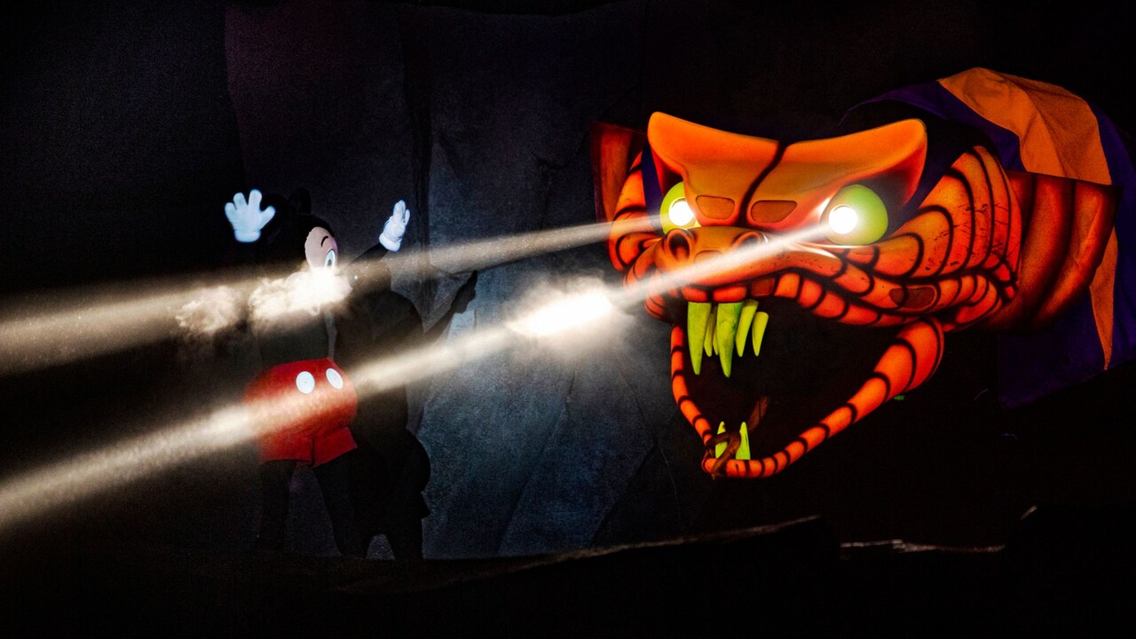 Mickey Mouse confronting Jafar, the giant snake with glowing eyes, during Fantasmic