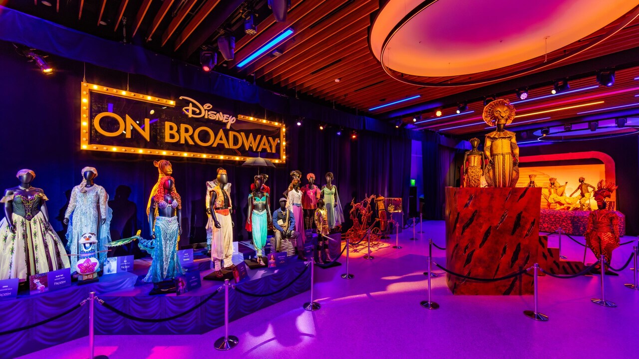 An exhibit displaying costumes from various musicals at Once Upon a Stage, The Magic of Disney On Broadway inside CommuniCore Hall at Epcot