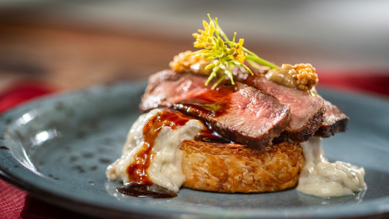 A serving of Beef Wellington inspired Croissant Supreme from The Craftsman’s Courtyard at the Epcot International Festival of the Arts