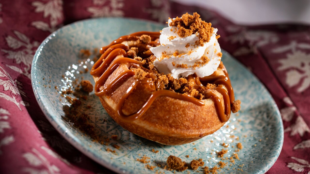 Belgian Waffle with cookie butter and whipped cream topped with speculoos cookie pieces