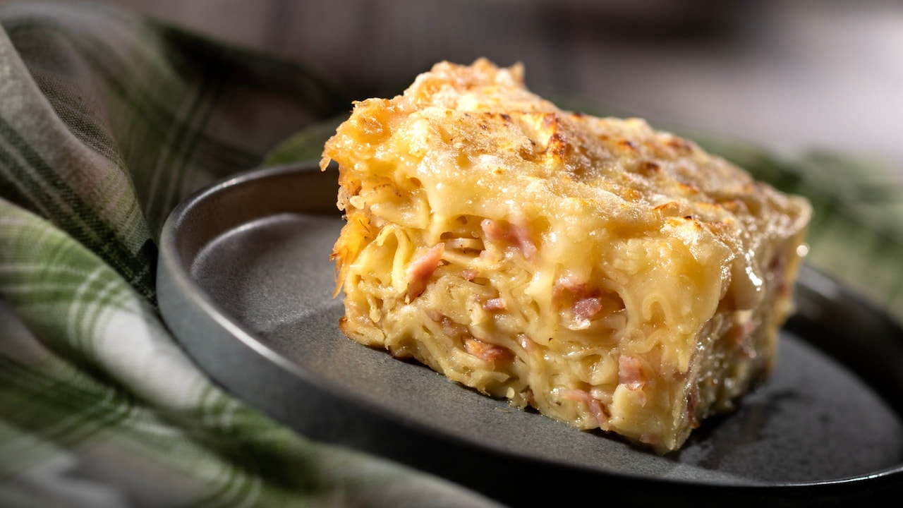 A slice of Schinkennudeln pasta gratin layered with ham, onions and melted cheese
