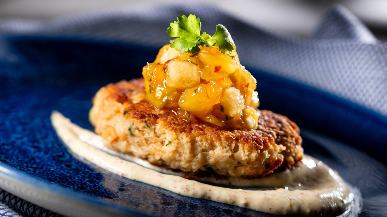Crab Cake, topped with tropical fruit chutney, mustard sauce and micro celery
