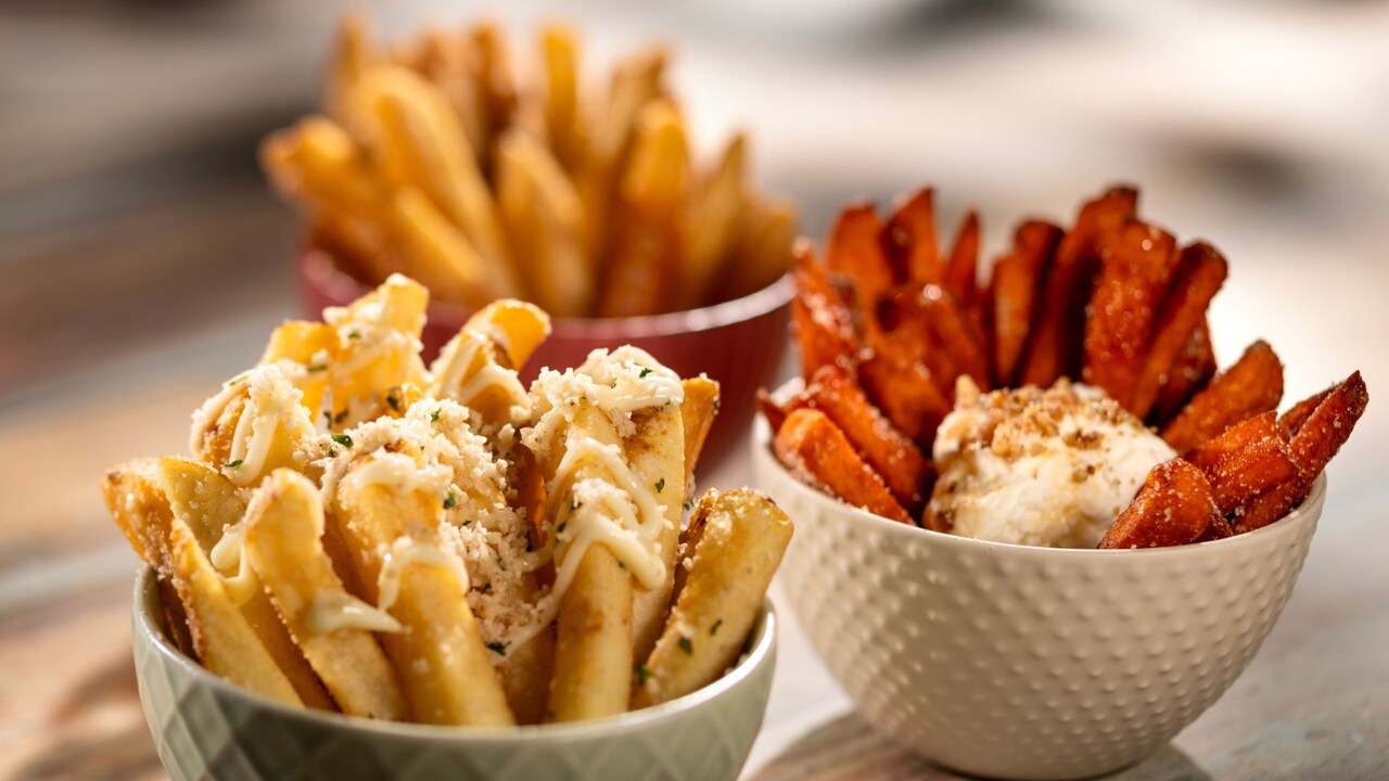 A flight of Sea Salt Malt Vinegar Fries, Truffle Parmesan Fries and Sweet Potato Casserole Fries