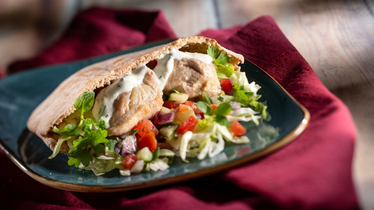 Chicken Souvlaki Gyro, with shaved lettuce, tomato cucumber relish and tsatsiki on warm pita