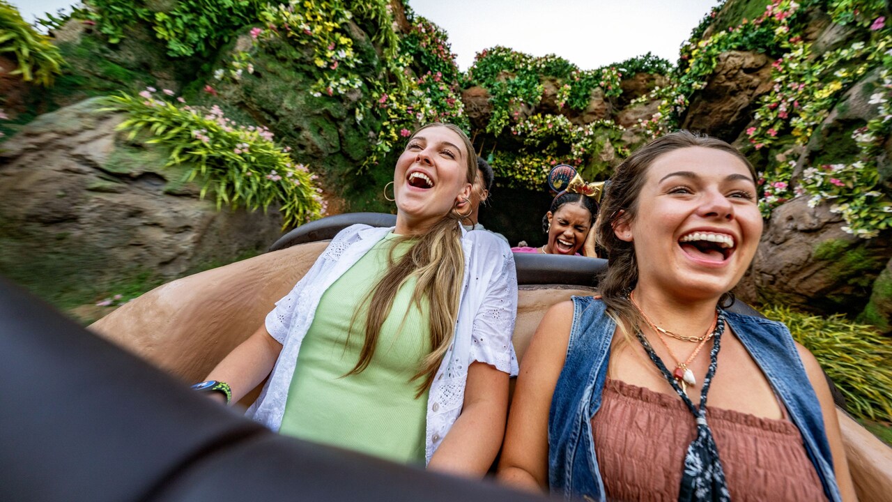 Guests smiling while riding down a drop in Tiana’s Bayou Adventure at Magic Kingdom park