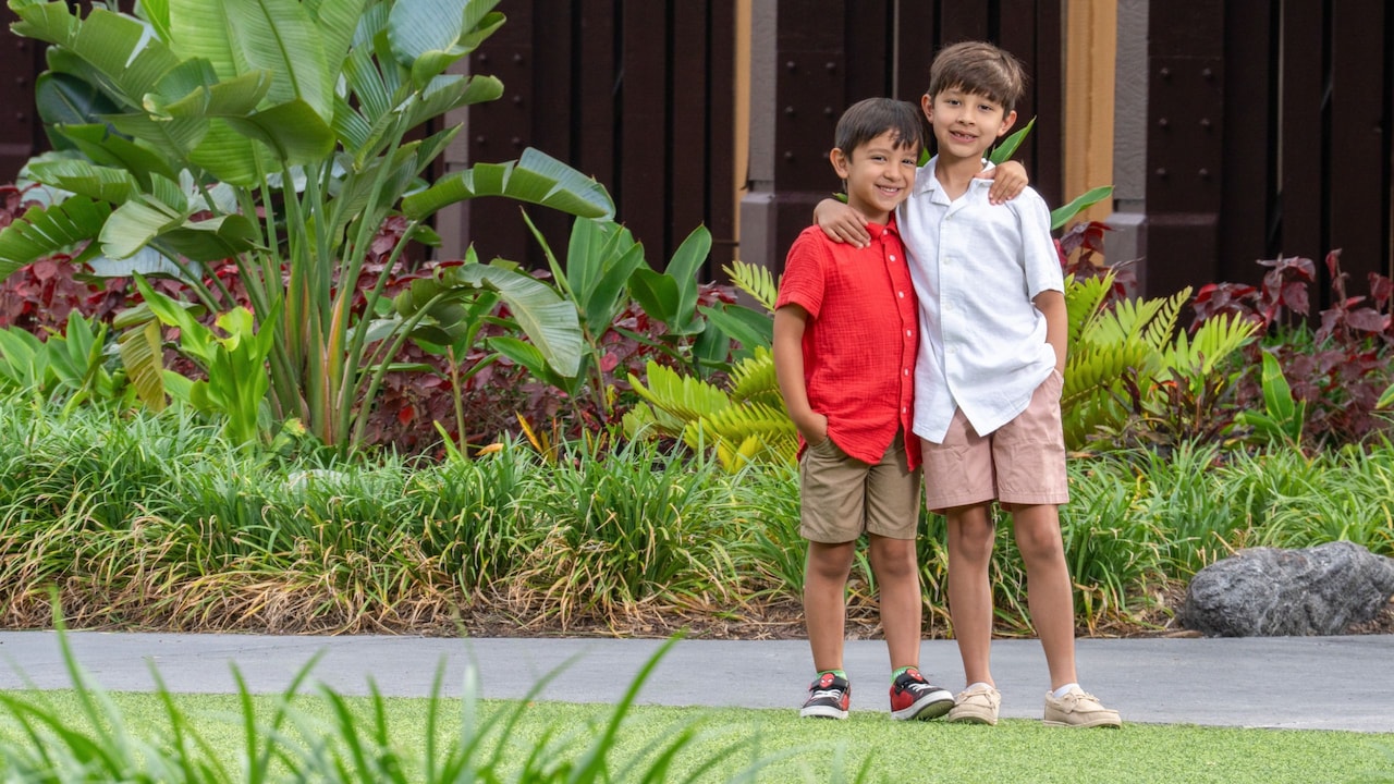 Two young children standing together during a portrait session at Walt Disney World Resort