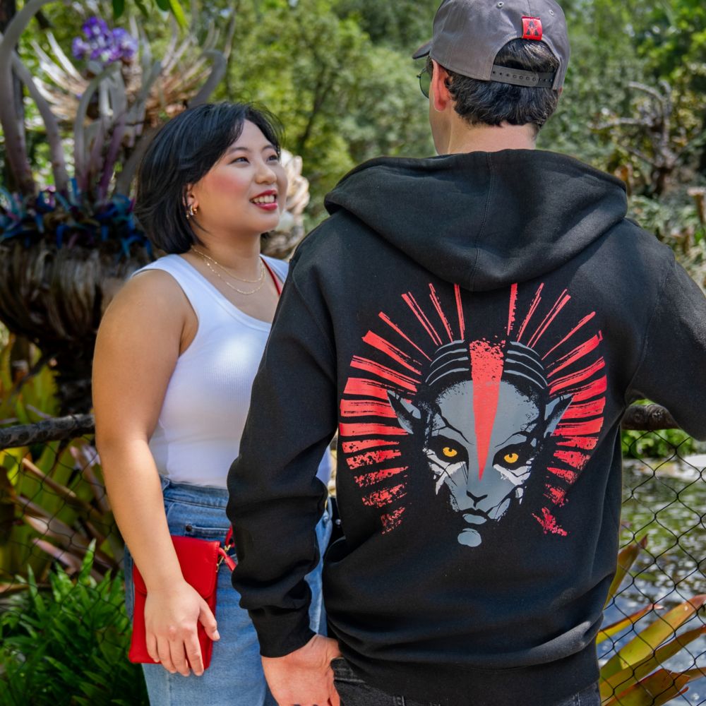 A Guest showing off the Avatar Fire and Ash artwork on his zip up hoodie at Pandora The World of Avatar in Disney's Animal Kingdom theme park