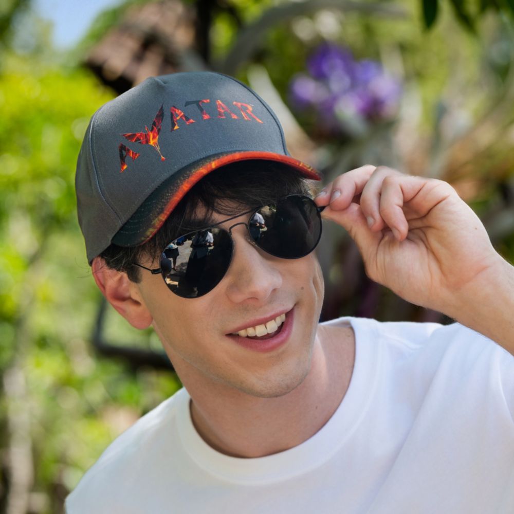 A Guest wearing an Avatar Fire and Ash cap at Pandora The World of Avatar in Disney's Animal Kingdom theme park