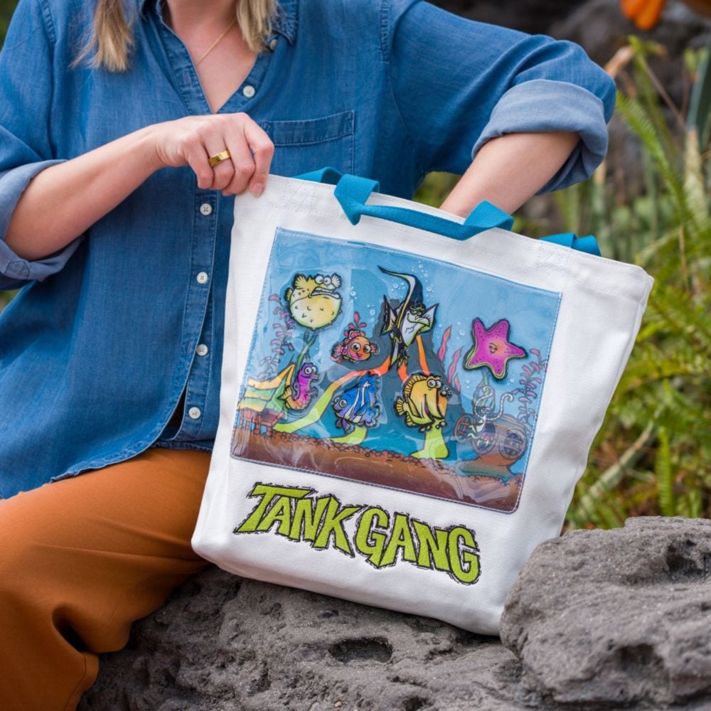 A Guest reaching into a Finding Nemo themed tote bag labeled ‘Tank Gang’