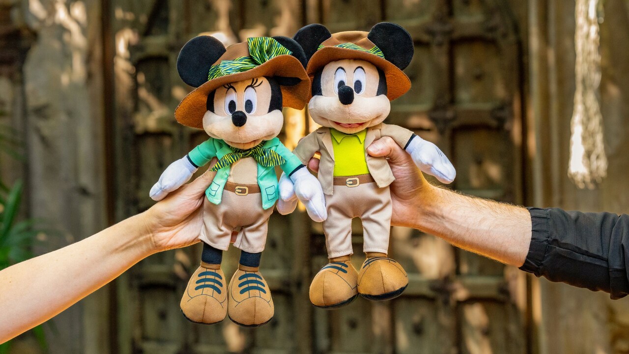 A Guest holding a display case featuring Moana Disney pins in front of a trading board