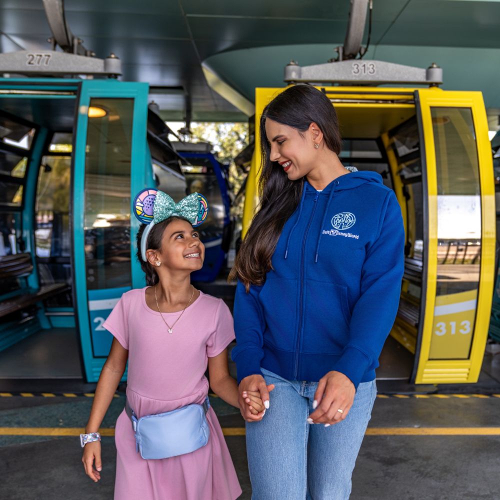 Guests wearing Walt Disney World Resort apparel as they exit the Disney Skyliner