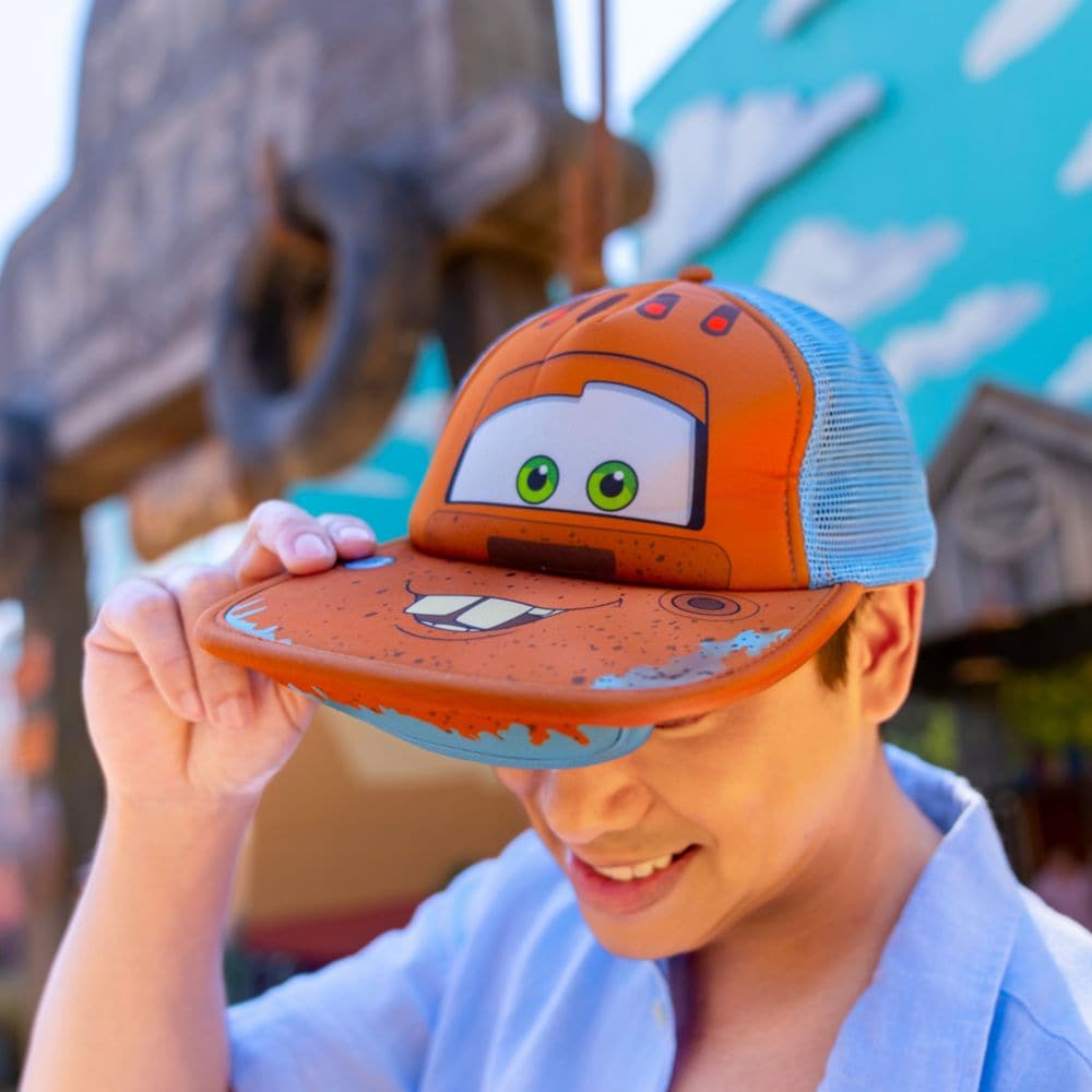 A Guest wearing a hat featuring Tow Mater