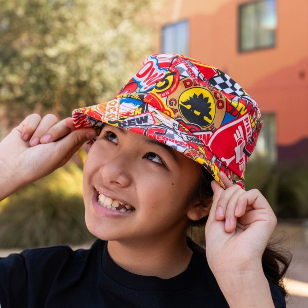 A Guest wearing a bucket hat featuring a design inspired by Cars