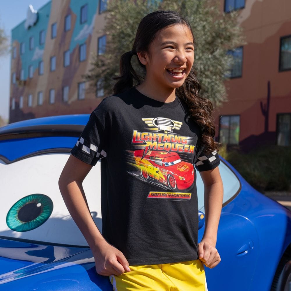 A Guest wearing a Lightning McQueen shirt at Disney's Art of Animation Resort