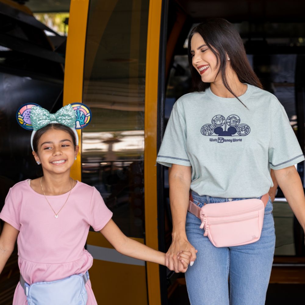 A mother and daughter holding hands while exiting the Disney Skyliner at Walt Disney World Resort