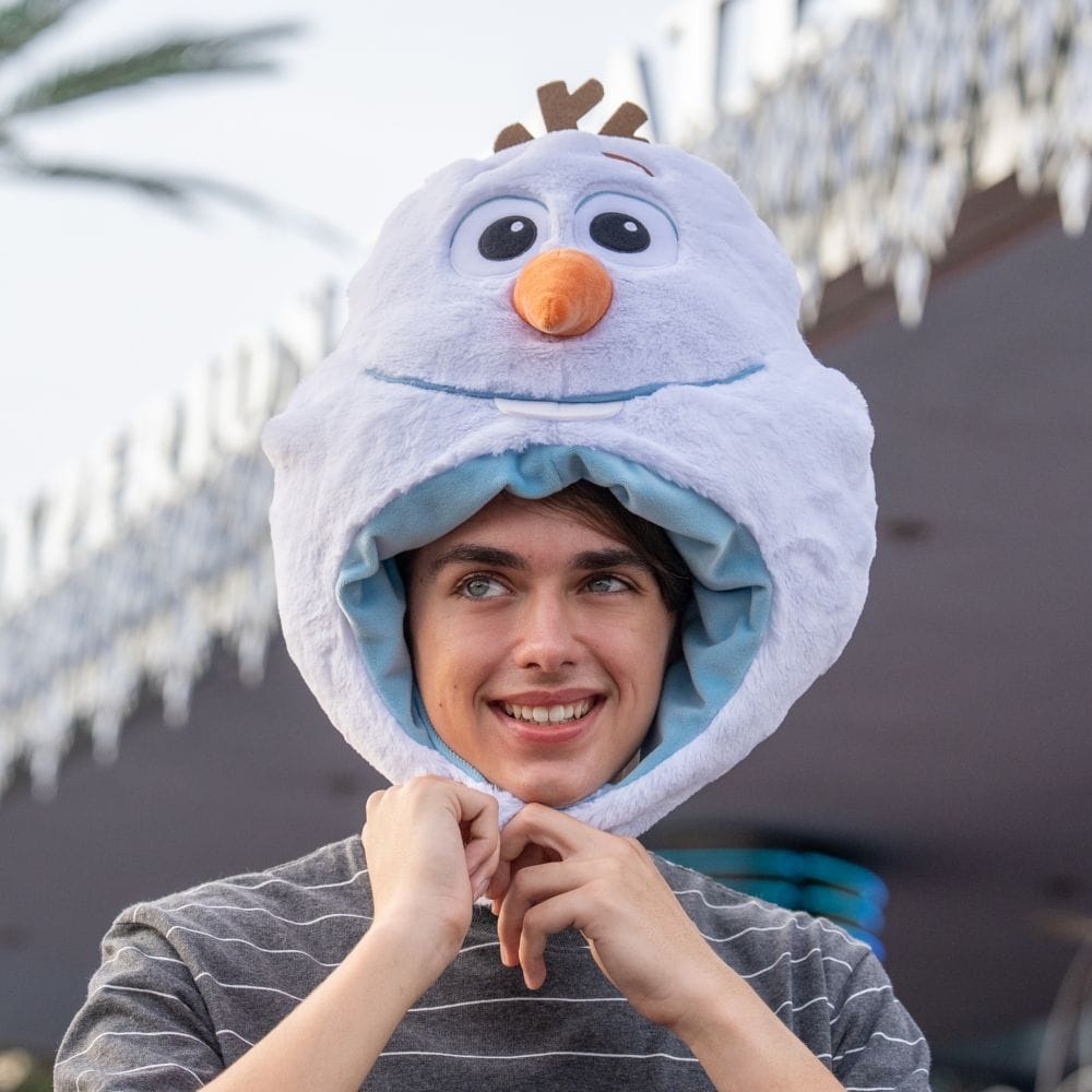 A man wearing a plush Olaf hat
