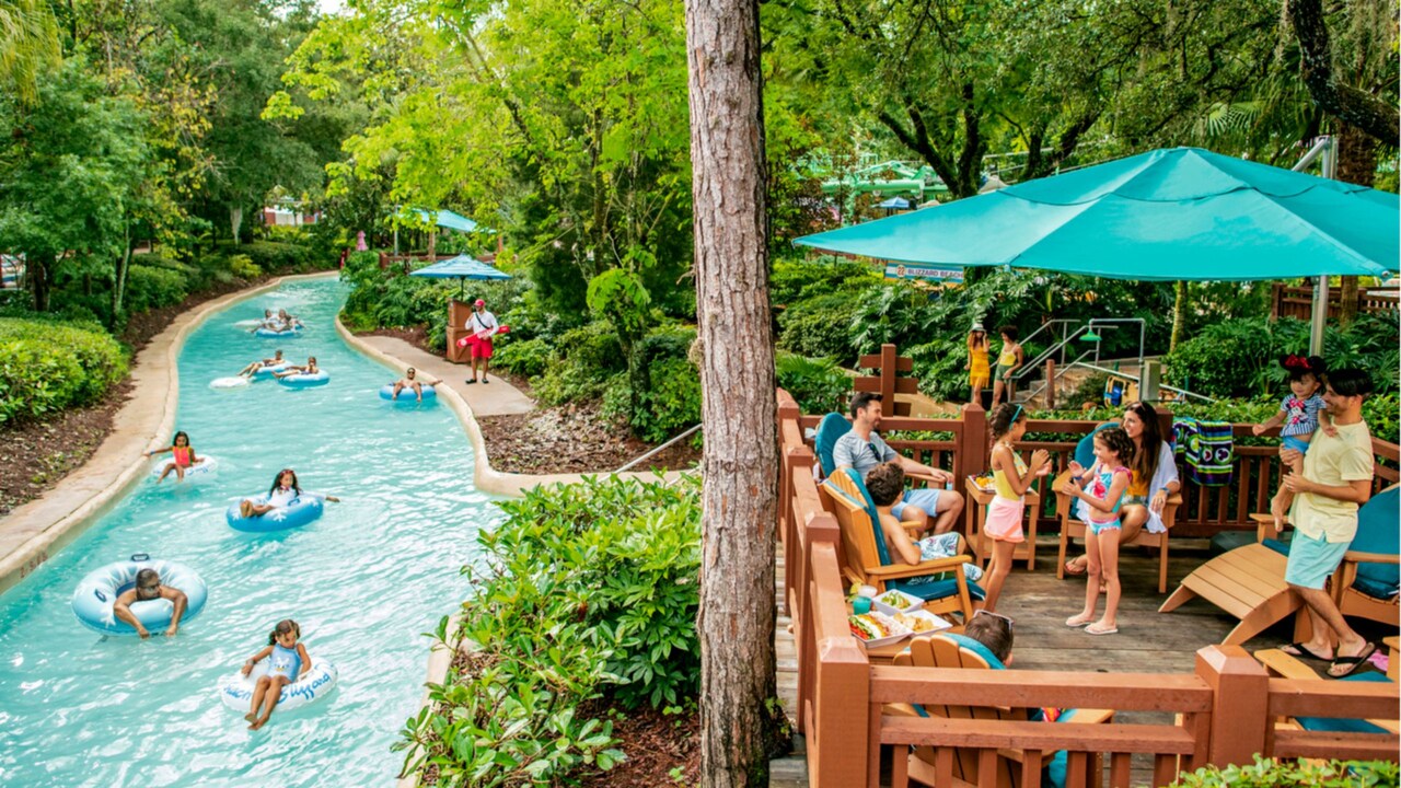 Guests relaxing on a deck perched over the Cross Country Creek lazy river