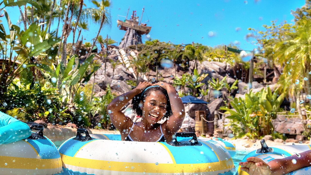 Guests floating in inner tubes in Castaway Creek at Disney’s Typhoon Lagoon water park