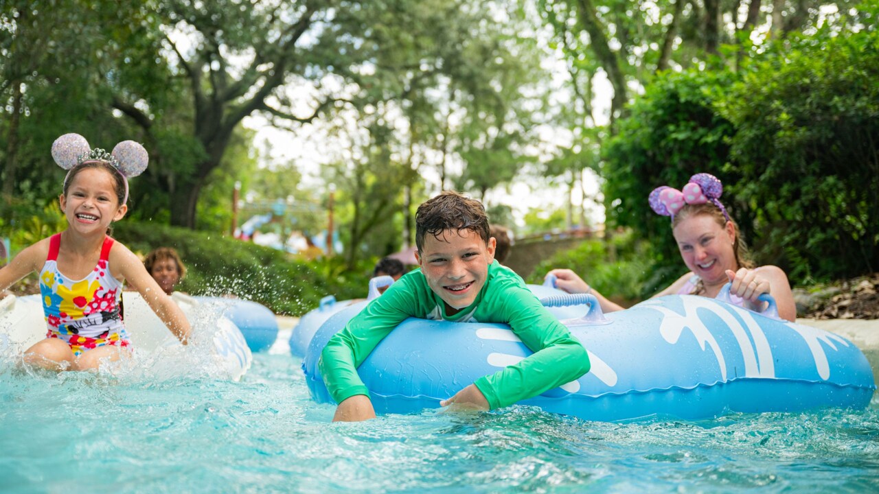 4 children floating on inner tubes in a lazy river