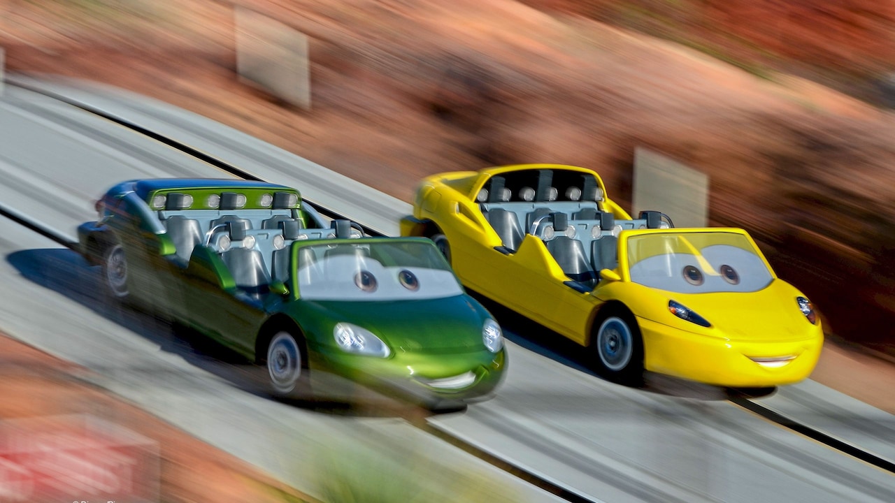 Two Cars racing through Radiator Springs Racers
