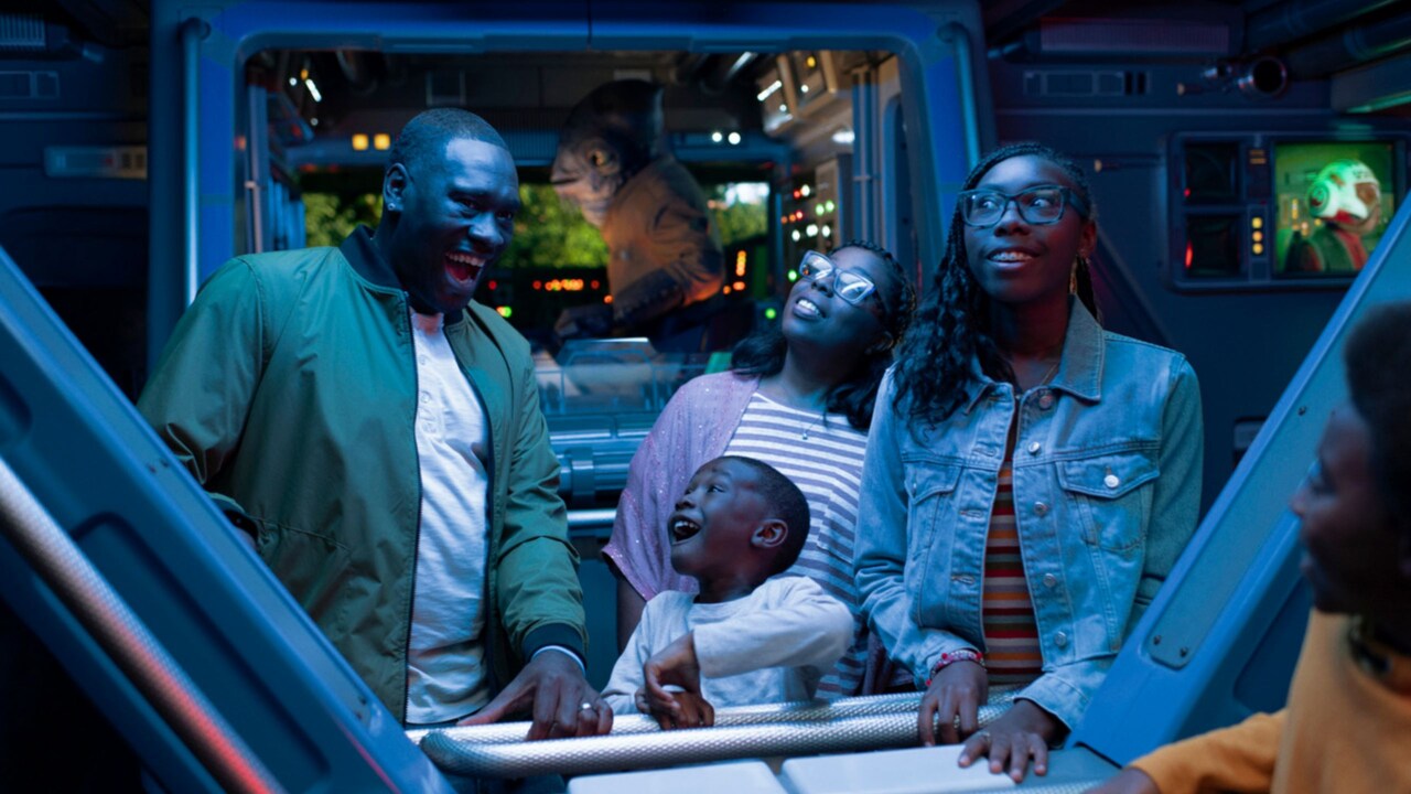 A family standing inside the Star Wars Rise of the Resistance attraction