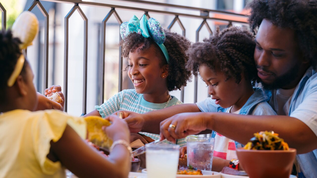 A family eating Mexican food at an outdoor table at Céntrico	