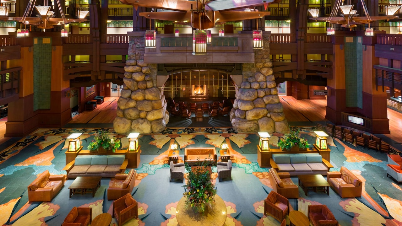 The lobby of Disney’s Grand Californian Hotel & Spa featuring a fireplace, atrium and seating areas