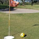 A soccer ball near a sand hazard on a FootGolf course