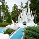 A miniature golf course hole featuring Cinderella Castle made of faux snow at Disneys Winter Summerland Miniature Golf Course