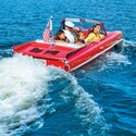 A mother and her 2 daughters enjoy a captain guided cruise aboard a vintage amphicar