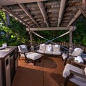 Beachcomber Shack Premium Plus seating area with cushioned chairs, towels, TV and mini fridge