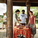 Guests socializing around a table of snacks at a patio in Harambe Wildlife Preserve